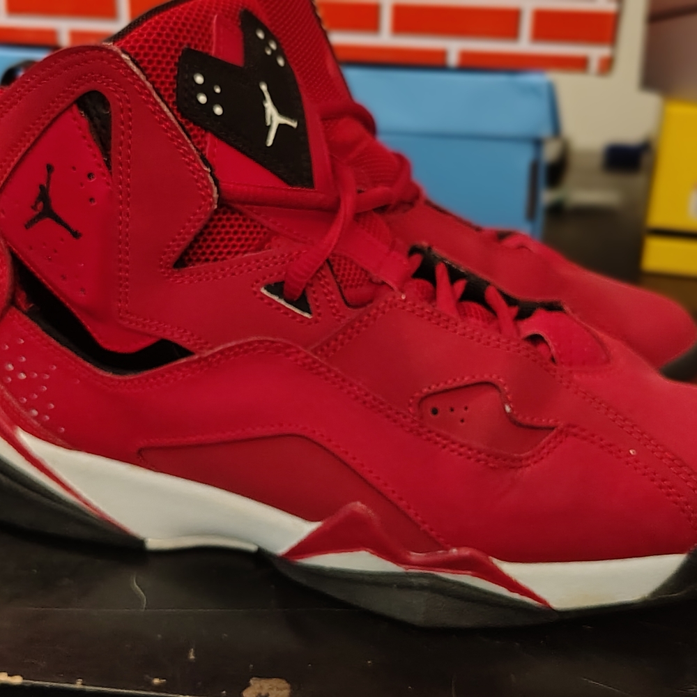 Jordan True Flight shoes in the "Gym Red" colorway.